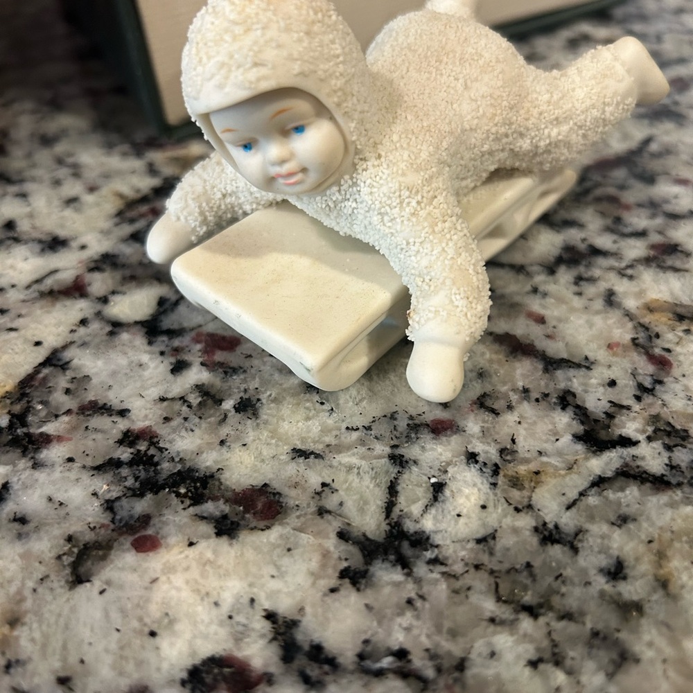 Vintage White PIECE OF THE  SNOW BABIES COLLECTION SNOW Baby on a sled.